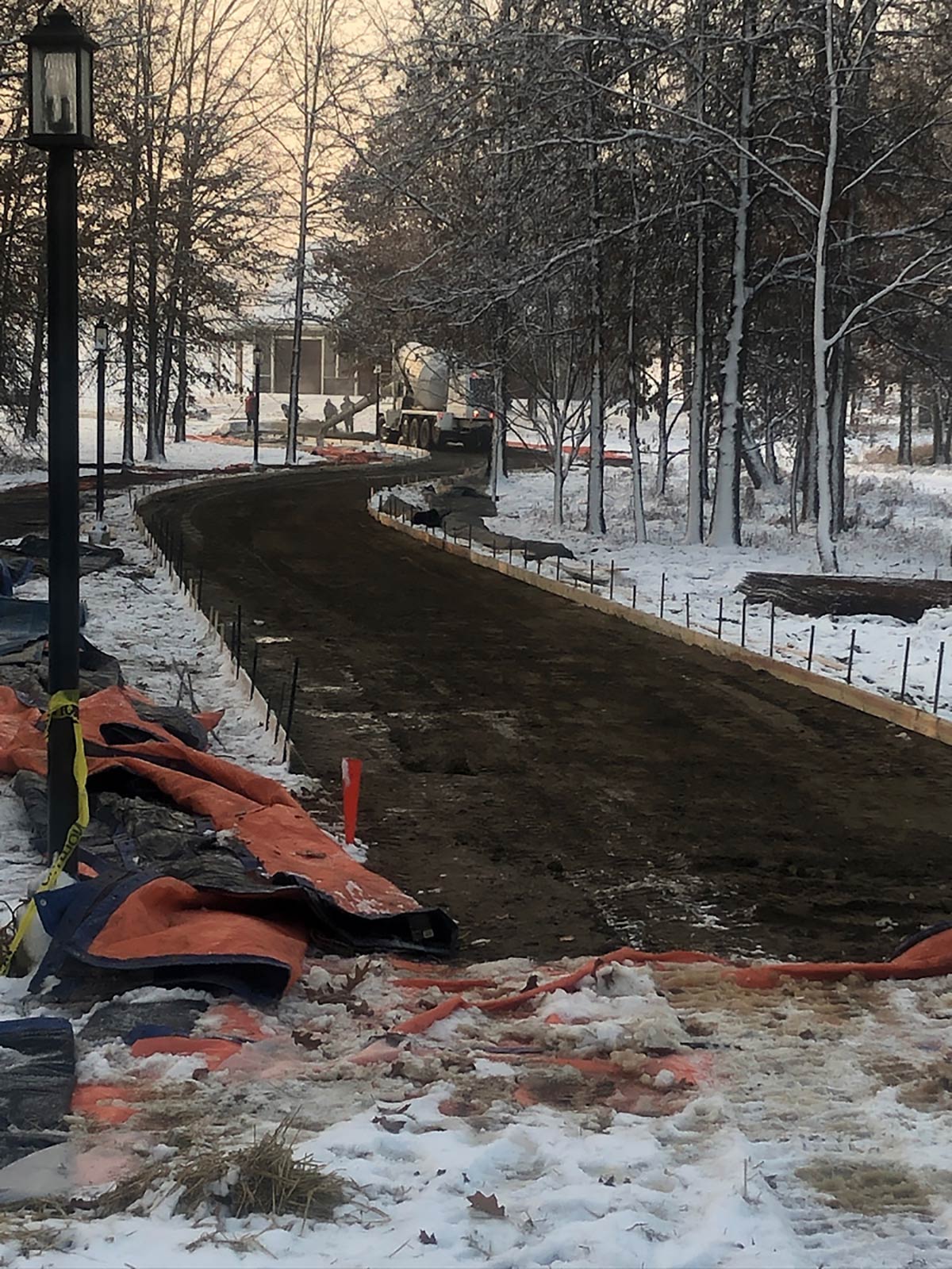 long curved driveway being poured with concrete