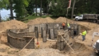 curved foundation being poured with pump truck