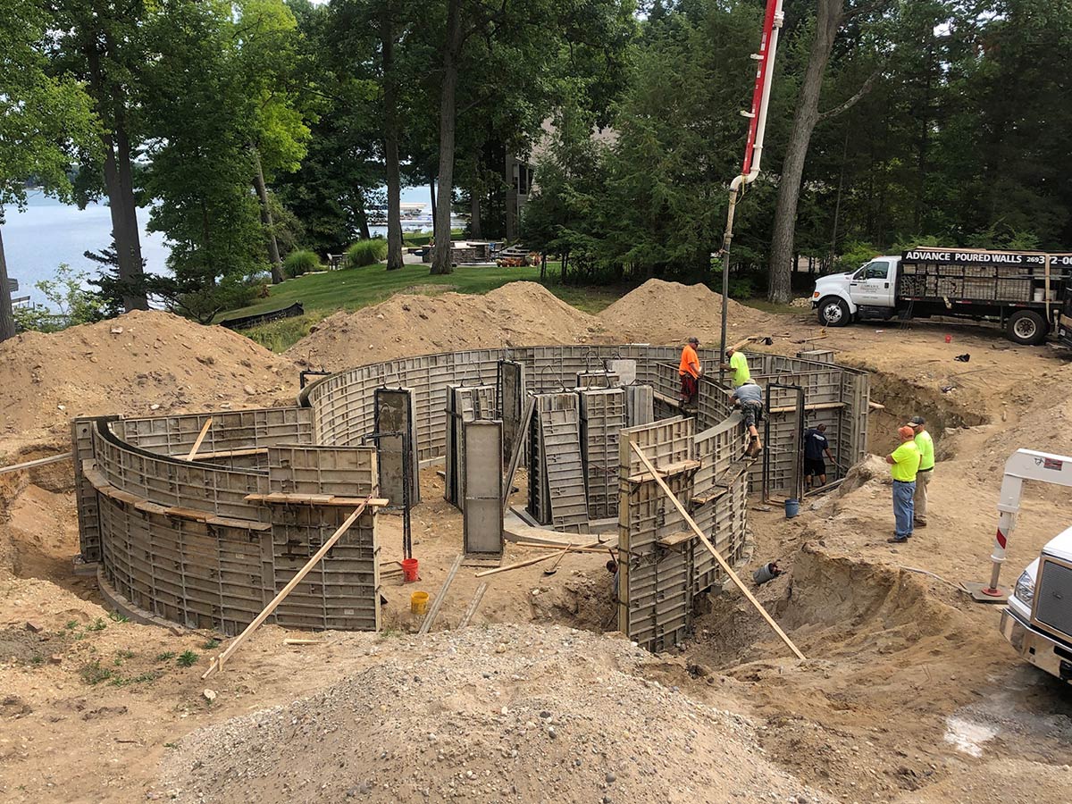 curved foundation being poured with pump truck
