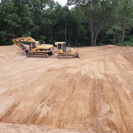 excavator and bulldozer in graded area