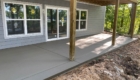 freshly poured concrete patio under deck