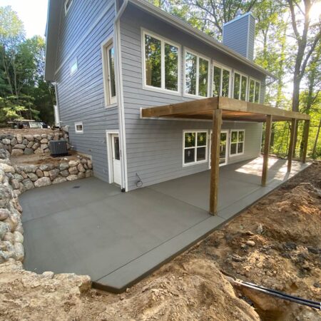 new concrete patio under deck