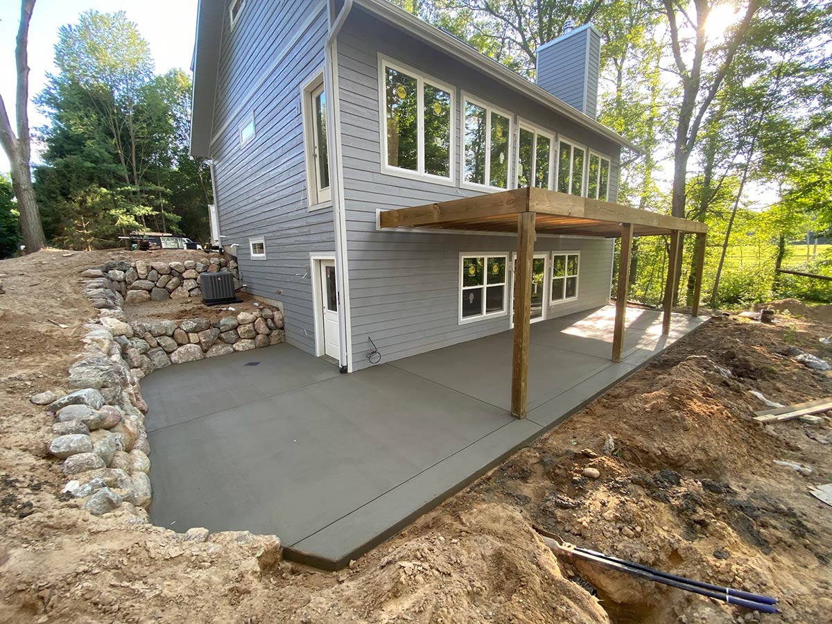 new concrete patio under deck