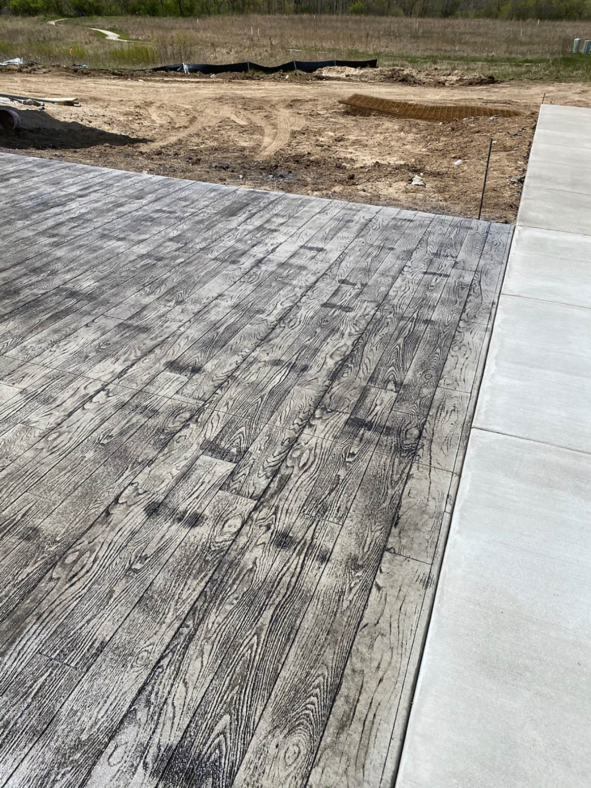 stamped concrete with wood grain and sidewalk
