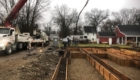 job site with forms and trucks and crew in background