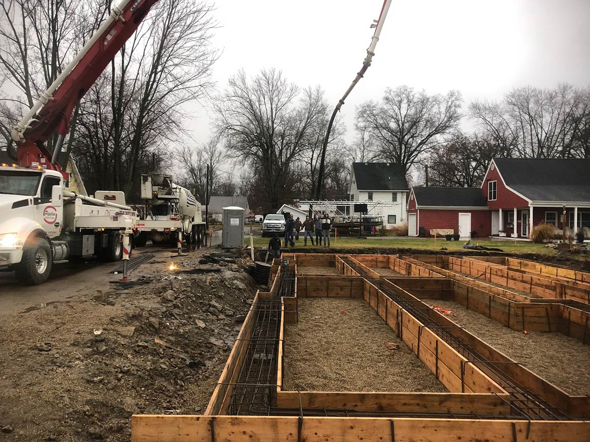 job site with forms and trucks and crew in background