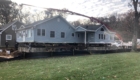 house raised up over forms for pouring new foundation