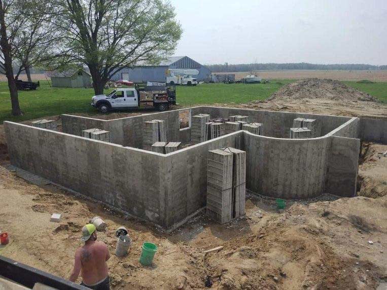 newly poured foundation at excavated job site