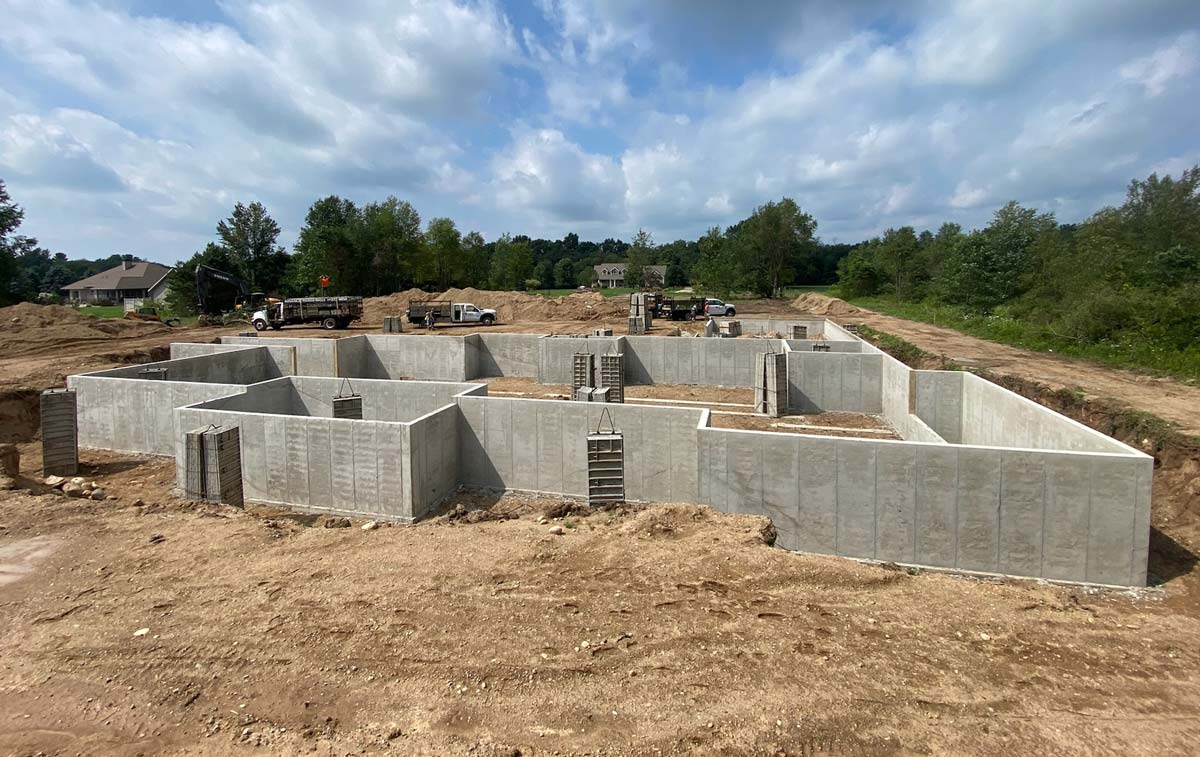 job site with newly poured concrete foundation walls